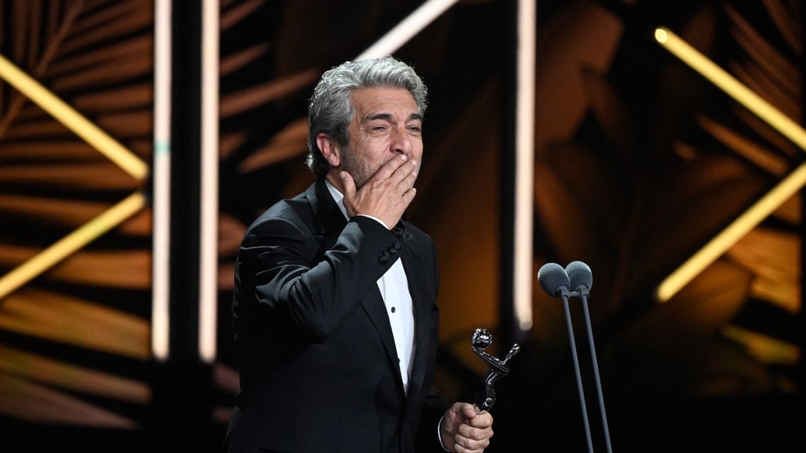 Argentinian actor Ricardo Darin greets the audience after receiving the Best Actor award in the '1985, Argentina' movie at the Platino Awards for Ibero-American cinema ceremony at the Ifema congress centre in Madrid.
