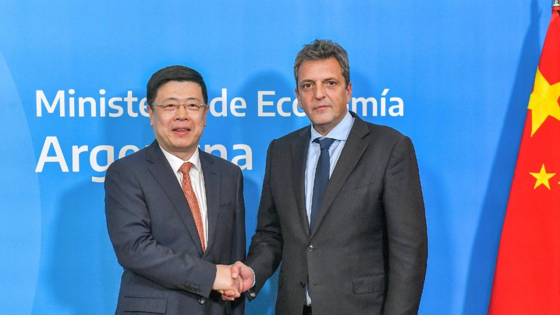 Handout photo released by the Economy Ministry shows Sergio Massa and Chinese Ambassador to Argentina Zou Xiaoli shaking hands after signing an agreement to activate the swap between Argentina and China in Buenos Aires on April 26, 2023. 