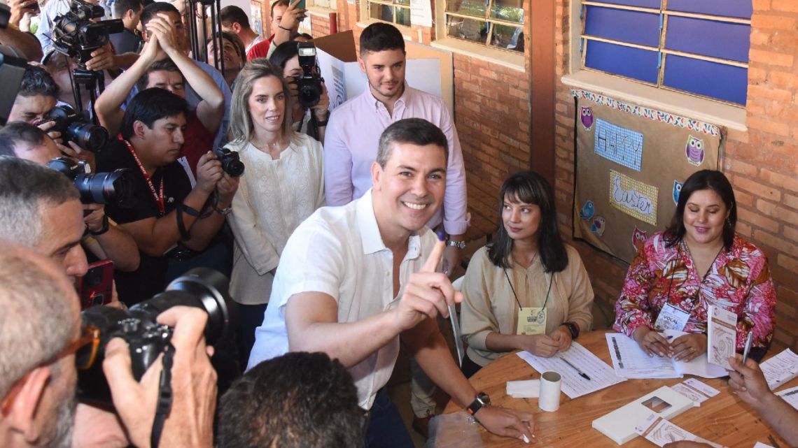 Paraguayan presidential candidate for the Colorado party, Santiago Peña, shows his inked finger after casting his vote at the Santa Ana school in Asunción, on April 30, 2023