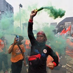 Manifestantes echan humo de colores mientras participan en una protesta en Yakarta, Indonesia. | Foto:ADEK BERRY / AFP