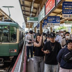 Un grupo de personas desembarca de un tren en la estación de Kamakura, en la prefectura de Kanagawa, Japón. | Foto:YUICHI YAMAZAKI / AFP