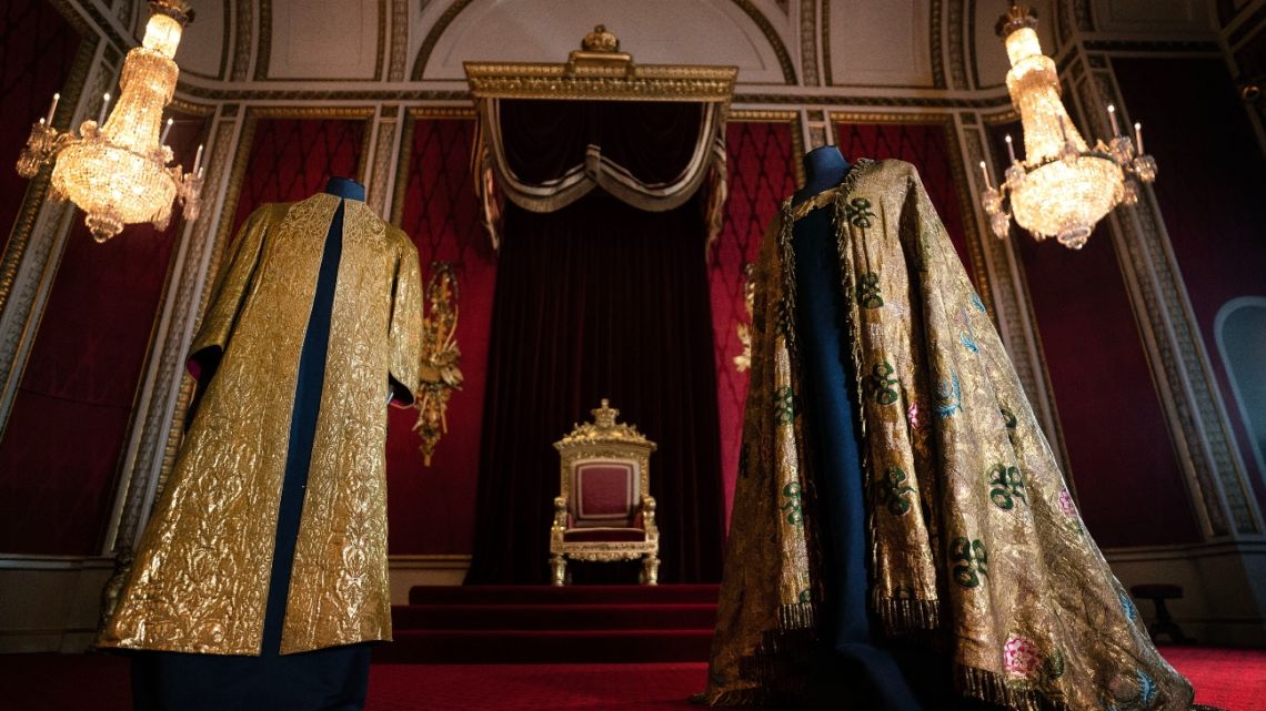The Coronation Vestments, comprising of the Supertunica (L) and the Imperial Mantle (R), which will be worn by King Charles III during his coronation, are displayed in the Throne Room at Buckingham Palace in London.