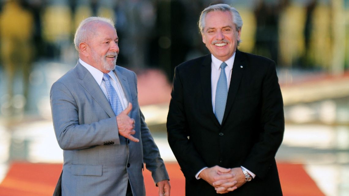 Brazilian President Luiz Inácio Lula da Silva greets President Alberto Fernández at the Alvorada Palace in Brasilia on May 2, 2023. 