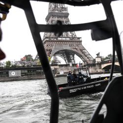 Miembros de la Brigada Fluvial de la policía francesa patrullan en botes cerca de la torre Eiffel y el puente Iena en el río Sena en París. | Foto:CHRISTOPHE ARCHAMBAULT / AFP