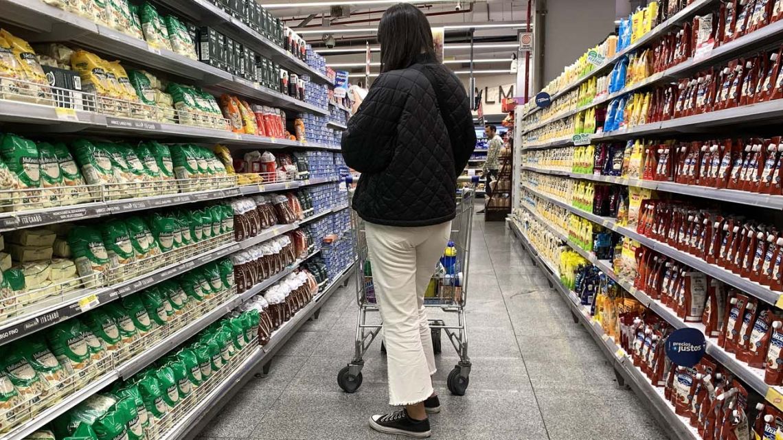 A woman observes food prices at a supermarket in Buenos Aires on May 11, 2023.