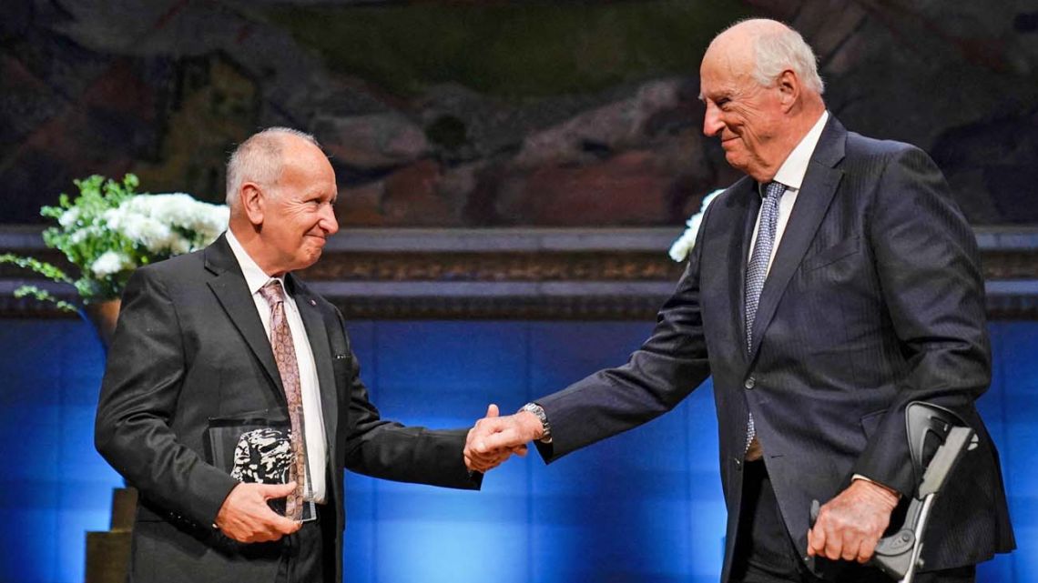 Norway's King Harald (rights) awards The Abel Prize 2023 to Argentine-American Luis Caffarelli, an expert in "partial differential equations" which can explain phenomena ranging from how water flows to population growth, at the University's Auditorium in Oslo, Norway, on May 23, 2023. 