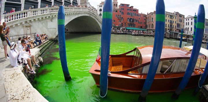 La foto tomada y difundida por la agencia de noticias italiana Ansa muestra aguas de color verde fluorescente bajo el puente de Rialto, en el Gran Canal de Venecia. El prefecto convocó una reunión urgente con la policía para investigar el origen del líquido, ya que los gondoleros se perdían en conjeturas sobre el origen del color.
