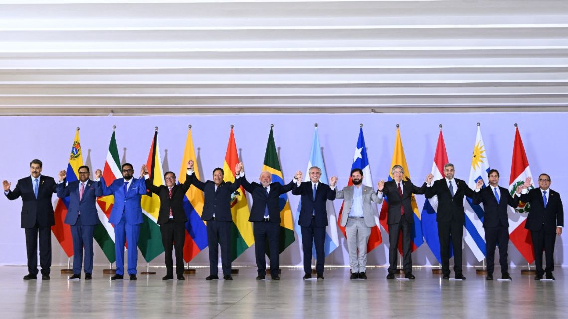 L-R) Venezuela's President Nicolás Maduro, Suriname's President Chan Santokhi, Guyana's President Irfaan Ali, Colombia's President Gustavo Petro, Bolivia's President Luis Arce, Brazil's President Luiz Inácio Lula da Silva, Argentina's President Alberto Fernández, Chile's President Gabriel Boric, Ecuador's President Guillermo Lasso, Paraguay's President Mario Abdo Benítez, Uruguay's President Luis Lacalle Pou and Peru's Prime Minister Alberto Otarola pose for a family photo at the Itamaraty Palace in Brasília on May 30, 2023. Brazilian President Luiz Inácio Lula da Silva called for South American unity Tuesday as he welcomed fellow leaders for a 'retreat' to strengthen ties in a region where left-wing governments are newly back in style.