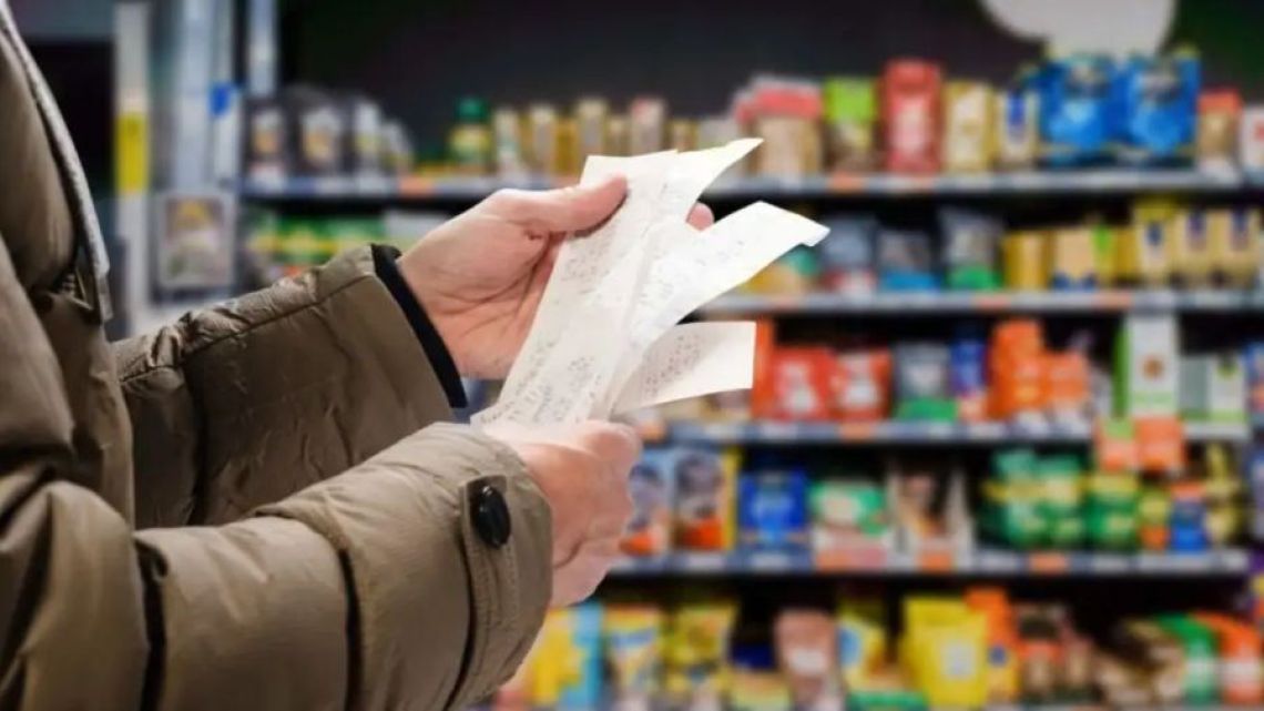 A shopper checks his bill at a supermarket in Buenos Aires.