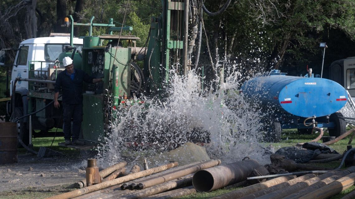 Workers of the state-owned water company Obras Sanitarias del Estado (OSE) drill boreholes to extract water in a park of Montevideo on June 6, 2023. 