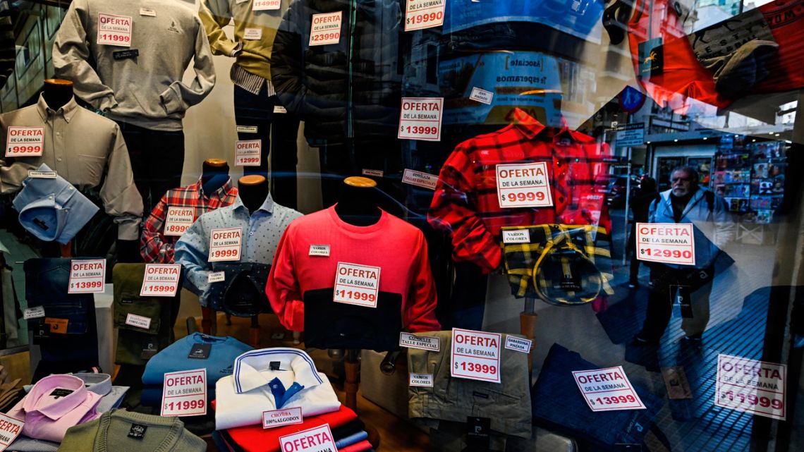 Clothes with price tags are seen in a window shop in Buenos Aires on June 12, 2023. 