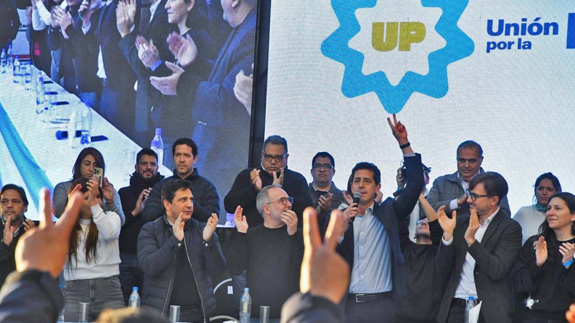 Interior Minister Eduardo 'Wado' de Pedro shows off the new 'Unión por la Patria' name at an event in Merlo.