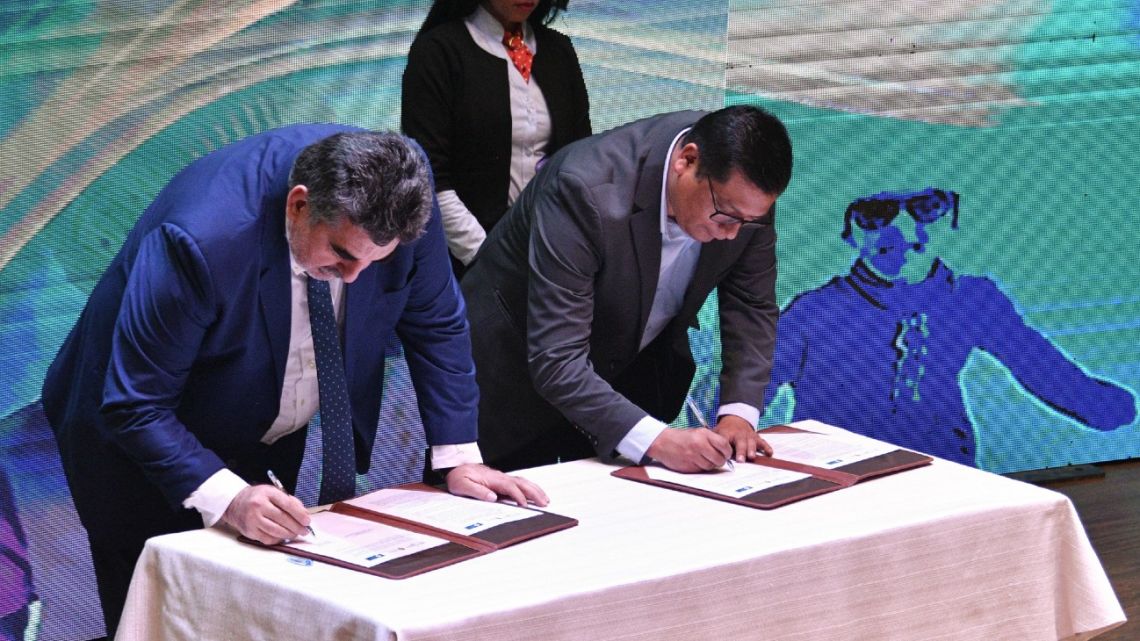 Carlos Ramos Mamani (R), president of Yacimientos Litio Boliviano (YLB), and Carlos Alberto Roca, legal representative of Uranium One Group (U1G), a subsidiary of Russia's Rosatom, sign an agreement for the industrialisation of lithium in La Paz on June 29, 2023. 