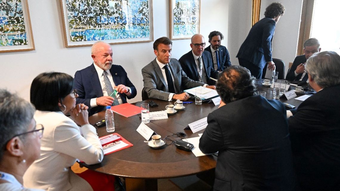 France's President Emmanuel Macron (C) speaks with Vice President of Venezuela Delcy Rodriguez (2L), Brazil's President Luiz Inacio Lula da Silva (3L), Colombia's President Gustavo Petro (from the back L) and Argentina's President Alberto Fernandez (from the back R) during a meeting on the sidelines of a summit of European Union-Community of Latin American and Caribbean States Summit (EU-CELAC) at The European Council Building in Brussels on July 17, 2023.