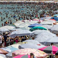 La gente se reúne en la playa de la ciudad de M'diq durante el 24º aniversario de la llegada al trono del rey Mohammed VI de Marruecos. | Foto:FADEL SENNA / AFP