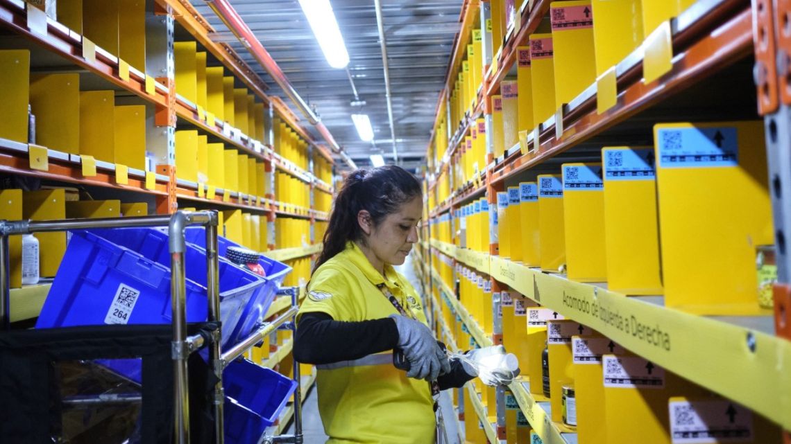 A worker scans products while gathering the items of an order at the MercadoLibre Distribution Center in Tepotzotlan, Mexico, on November 2022.
