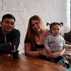 Oriana Gago and her partner Samir Santa Cruz stave off hunger by drinking yerba mate, making sure their daughter Chiara is properly fed. 