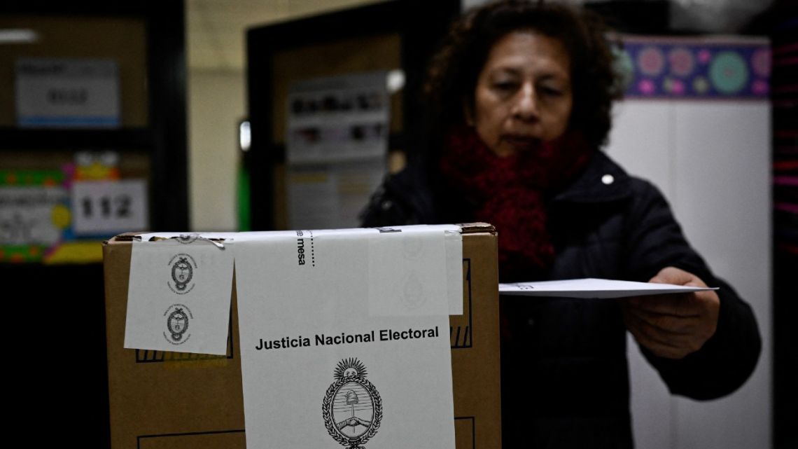 A woman casts her vote during primary elections at a polling station in Tigre, Argentina, on August 13, 2023. 