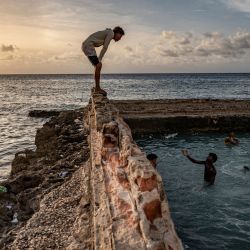 Los cubanos nadan en una piscina natural frente a las costas de La Habana. Con el caluroso verano actual, los habaneros se han apresurado a acudir a las dilapidadas piscinas naturales en la costa de su ciudad, construidas por familias adineradas en la primera mitad del siglo pasado. | Foto:YAMIL LAGE / AFP