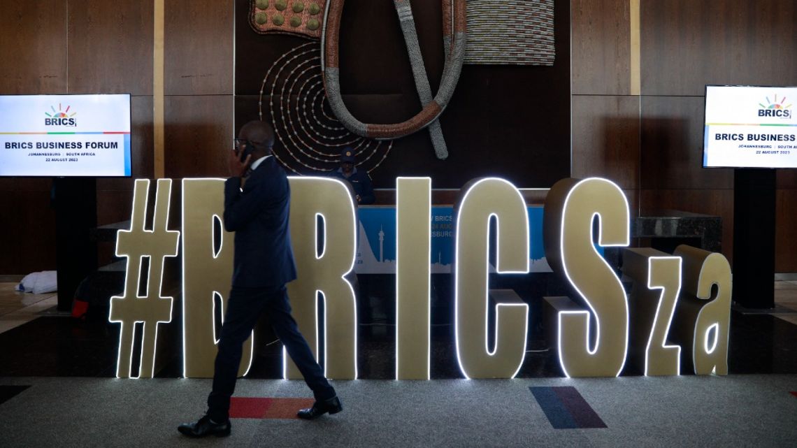 A delegate walks by the main foyer during the 2023 BRICS Summit at the Sandton Convention Centre in Johannesburg on August 22, 2023. 