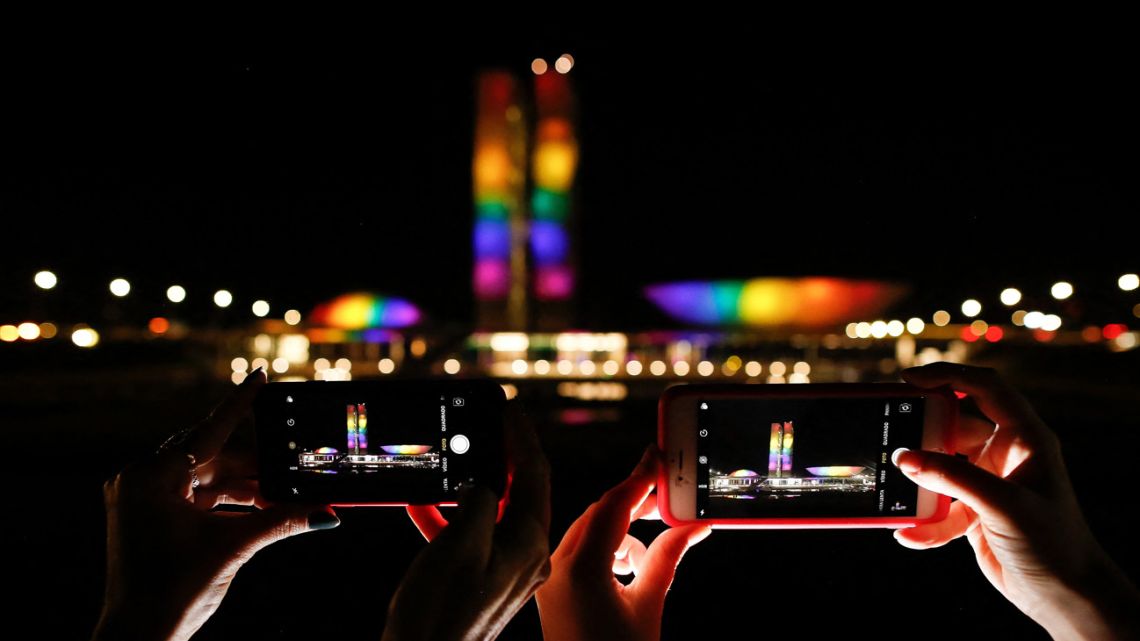 Brazilian National Congress is seen illuminated with the colors of the LGBT flag on the International Day against Homophobia, Transphobia and Biphobia, in Brasilia, May 17, 2022.