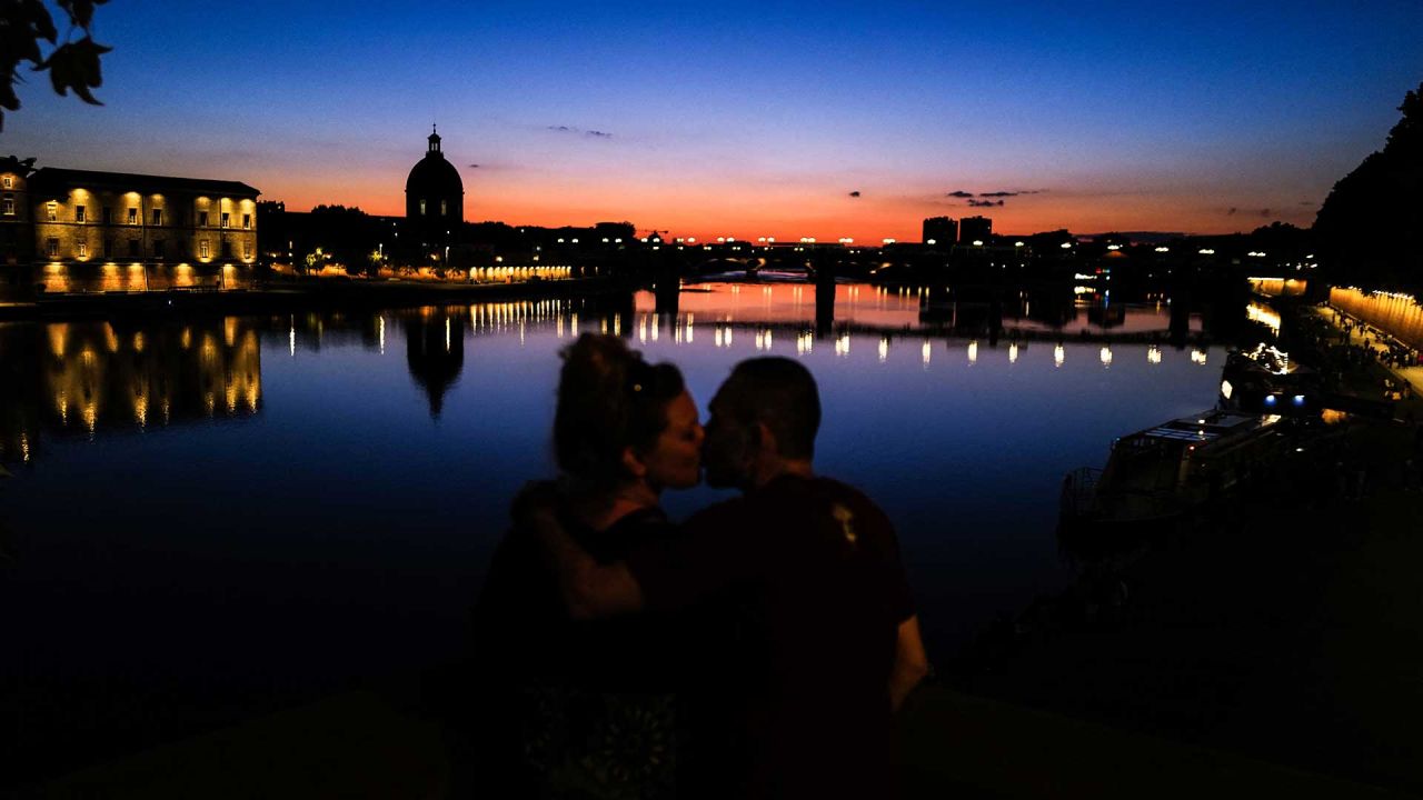 Una pareja se besa junto al río Garona al atardecer con el monumento Dome de la Grave al fondo en Toulouse, suroeste de Francia. Foto de Charly TRIBALLEAU / AFP | Foto:AFP