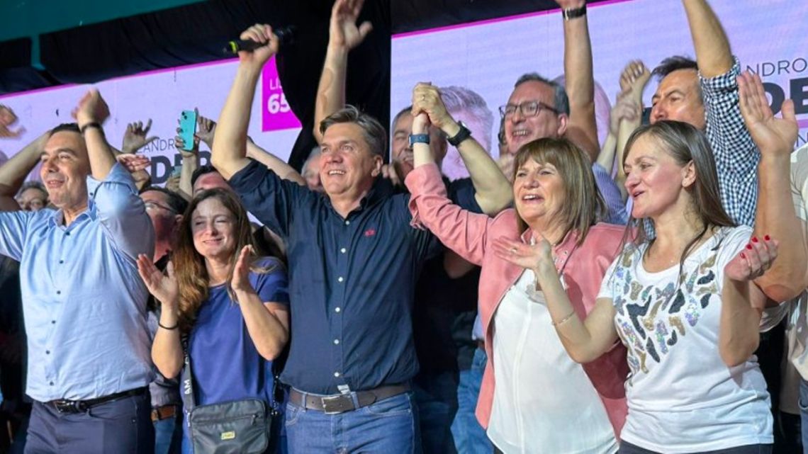 Leandro Zdero and Patricia Bullrich celebrate with their campaign teams onstage after the former's election victory in Chaco.