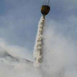 Un helicóptero arroja agua mientras los bomberos intentan extinguir un incendio que lleva cuatro días ardiendo en el vertedero de Putri Cempo en Solo, Java. Foto de DEVI RAHMAN / AFP | Foto:AFP