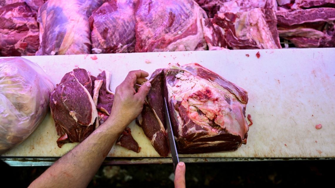 A worker cuts meat at a butcher shop in Buenos Aires on September 11, 2023. 