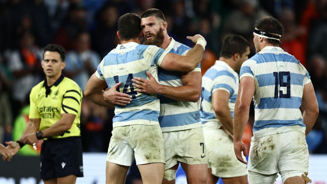 Argentina's openside flanker Marcos Kremer embraces wing Emiliano Boffelli as they celebrate after victory in the France 2023 Rugby World Cup Pool D match between Argentina and Samoa at Stade Geoffroy-Guichard in Saint-Étienne, south-eastern France on September 22, 2023. 