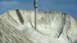 Lithium ore falls from a chute onto a stockpile