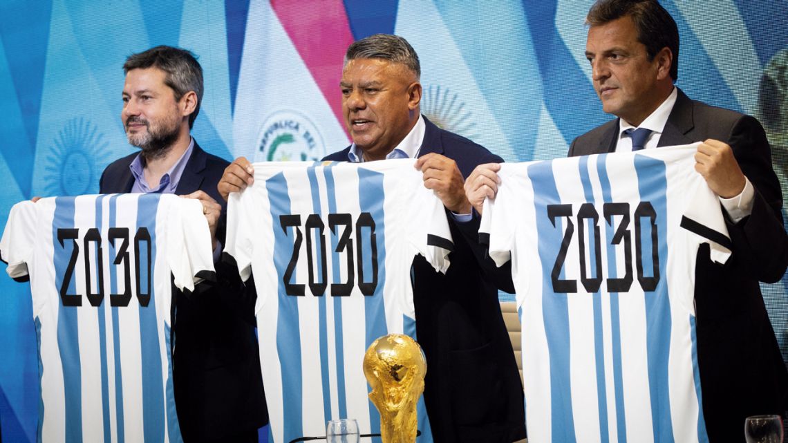 Tourism & Sports Minister Matías Lammens, the president of the Argentine Football Association (AFA), Claudio Tapia, and Economy minister and presidential candidate Sergio Massa hold up Argentina national team shirts with the year "2030" stamped on their back, during a press conference in Ezeiza on October 5, 2023, a day after the announcement that the "inaugural matches" of the 2030 World Cup will be played in Uruguay, Argentina and Paraguay. 