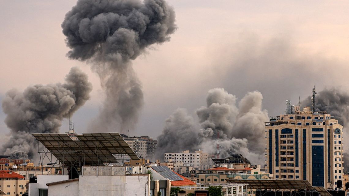 A plume of smoke rises in the sky of Gaza City during an Israeli airstrike on October 9, 2023. Israel relentlessly pounded the Gaza Strip overnight and into October 9 as fighting with Hamas continued around the Gaza Strip, as the death toll from the war against the Palestinian militants surged above 1,100. 