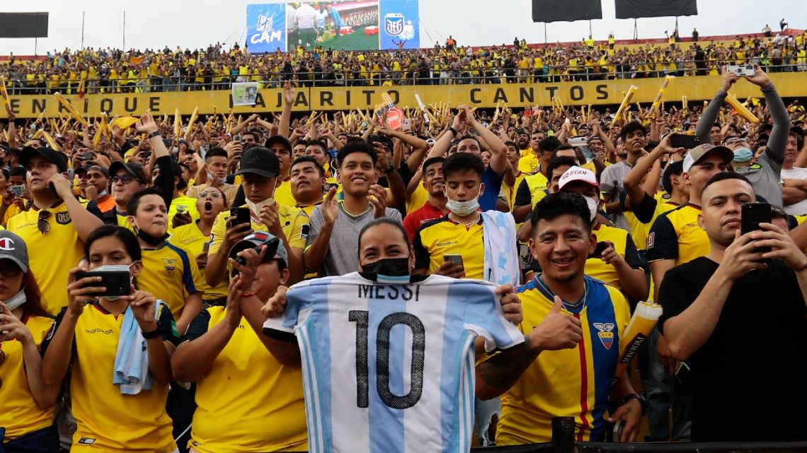 A fan of Ecuador holds a shirt of Argentina forward Lionel Messi while waiting for the start of the South American qualification football match for the FIFA World Cup Qatar 2022 against Argentina, at the Isidro Romero Monumental Stadium in Guayaquil, Ecuador, on March 29, 2022.