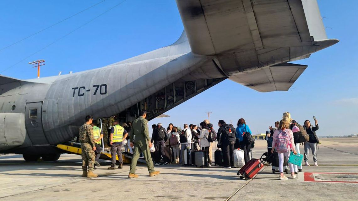 This handout picture released by the Foreign Ministry shows Argentine citizens boarding an Argentine Air Force C-130 Hercules aircraft at Ben Gurion International Airport in Tel Aviv, Israel, on October 12, 2023, bound for Mario de Bernardi Air Base near Rome, Italy. Thousands of foreigners are stuck in Israel and across the Palestinian territories, where a full-blown war has erupted since Hamas militants launched their attack. 