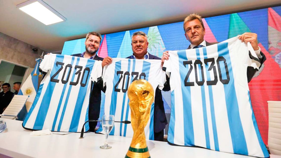 Tourism & Sports Minister Matías Lammens, the president of the Argentine Football Association (AFA), Claudio Tapia, and Economy minister and presidential candidate Sergio Massa hold up Argentina national team shirts with the year '2030' stamped on their back, during a press conference in Ezeiza on October 5, 2023, a day after the announcement that the inaugural matches of the 2030 World Cup will be played in Uruguay, Argentina and Paraguay. 