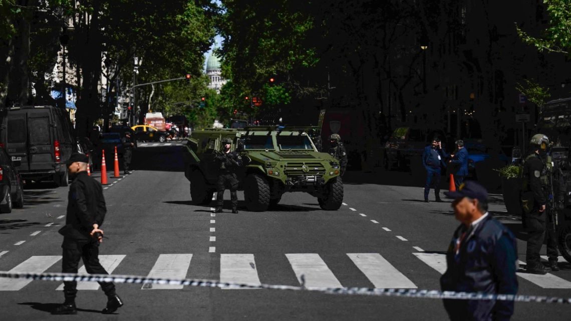 Federal Police officers stand guard on Avenida de Mayo during a security operation around the Israeli Embassy in Buenos Aires following a bomb threat, on October 18, 2023.