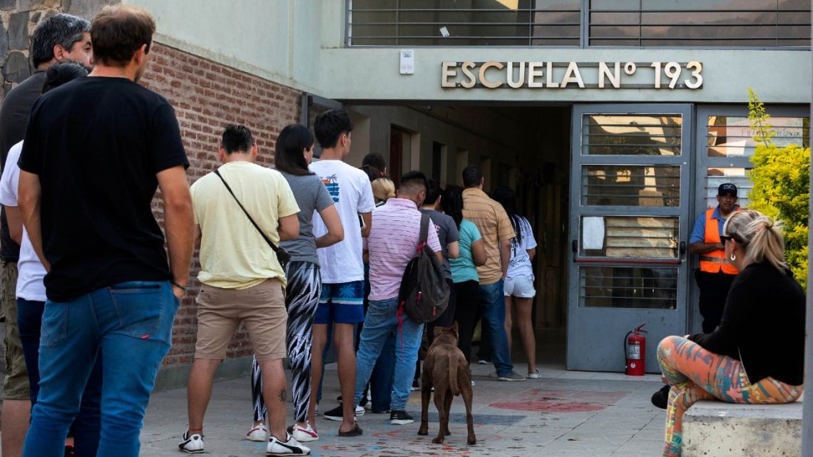 Voters queue up to cast their ballot in the presidential and provincial elections at a polling station at Escuela N° 193 de Valle Chico in Catamarca.