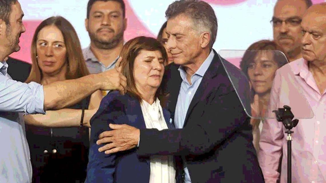 Patricia Bullrich comforts Mauricio Macri on election night after she finished third in the presidential ballot.