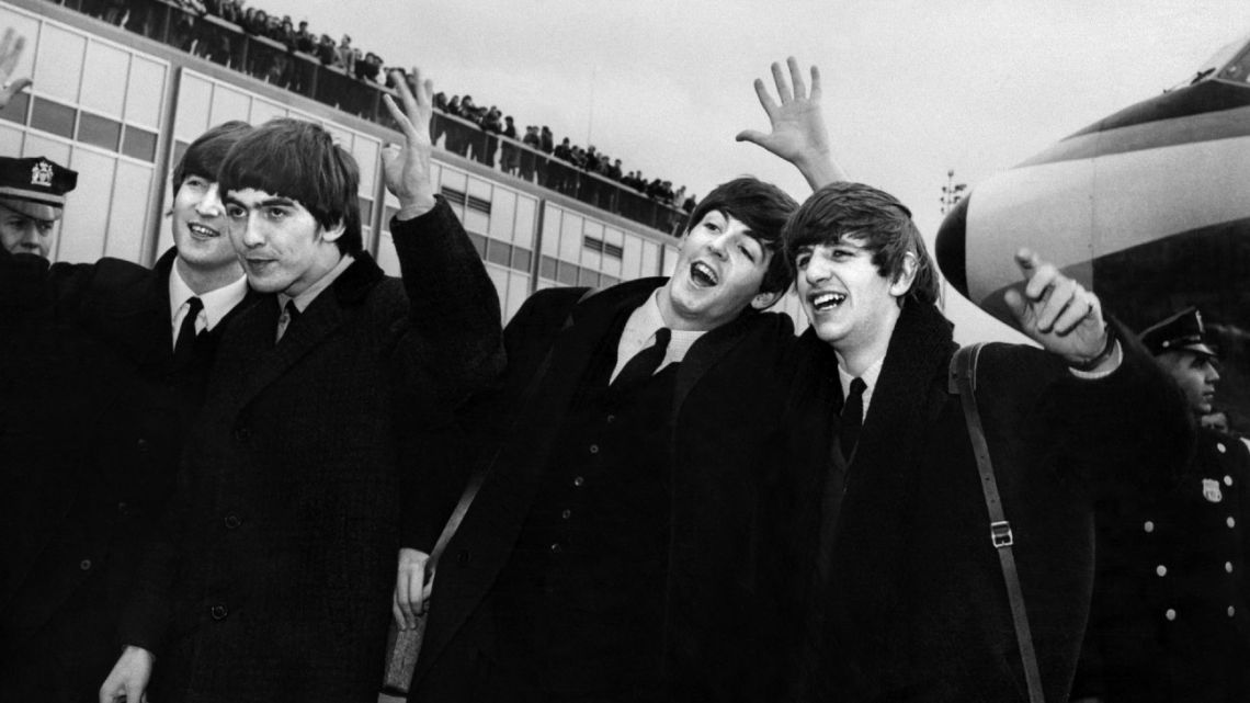 The Beatles – John Lennon, Ringo Starr, Paul McCartney and George Harrison – arrive at John F. Kennedy Airport in New York, United States, where they're greeted by a large crowd on February 7, 1964.
