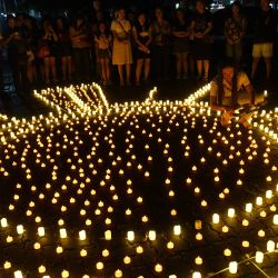 La gente coloca velas LED durante una vigilia en memoria de las víctimas del súper tifón Haiyan en el décimo aniversario del desastre en un parque en la ciudad de Tacloban, provincia de Leyte, Filipinas. | Foto:TED ALJIBE / AFP