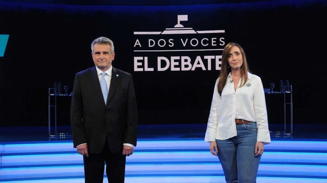 Agustín Rossi and Victoria Villarruel pose for a photograph after the vice-presidential debate.