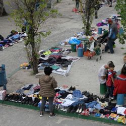 People offer used clothes for barter or sale at a sidewalk in Villa Fiorito – the childhood neighbourhood of late football star Diego Maradona – in Lomas de Zamora, Buenos Aires Province, on November 13, 2023 