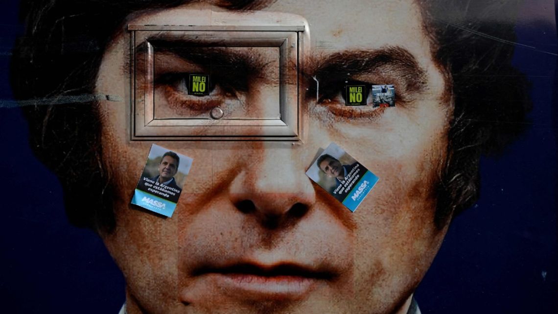 An image depicting Javier Milei is seen with stickers of Sergio Massa plastered on top, during a campaign rally in Ezeiza, Buenos Aires Province, on November 15, 2023. 