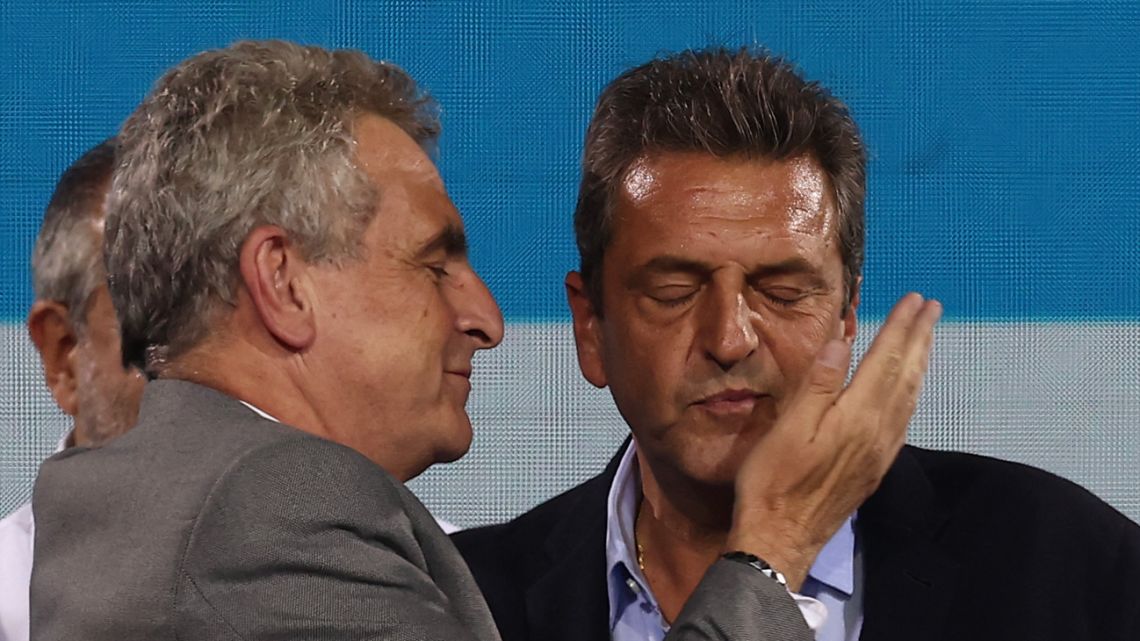 Economy Minister and unsuccessful presidential candidate for the Unión por la Patria party, Sergio Massa (centre), is greeted by his vice-presidential candidate, Agustín Rossi (left), after knowing the results of the presidential election run-off at his party's bunker in Buenos Aires on November 19, 2023. 