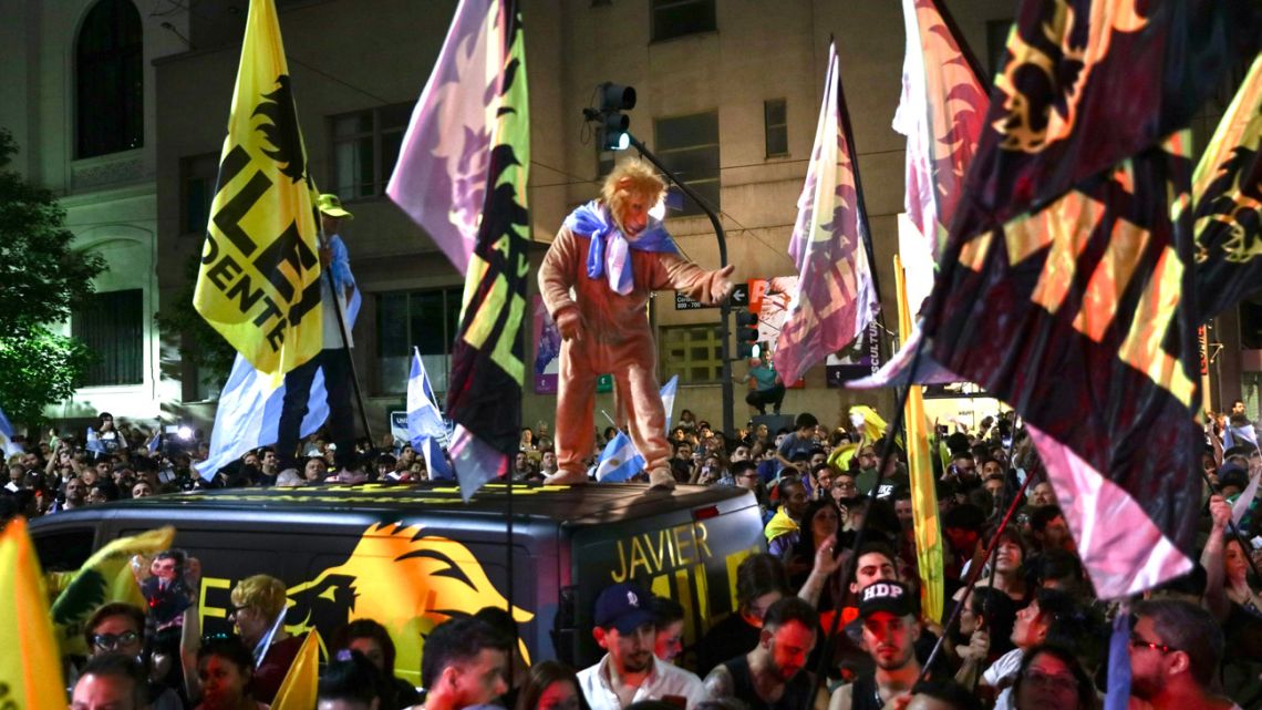 Supporters of presidential candidate for La Libertad Avanza, Javier Milei, celebrate after knowing the results of the presidential election run-off outside the party headquarters in Buenos Aires on November 19, 2023.