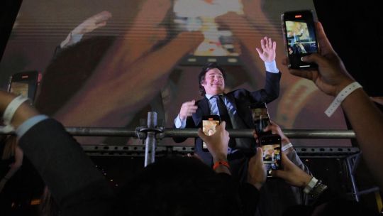 Javier Milei greets supporters on election night.