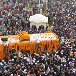 Los devotos sikh se reúnen alrededor de un autobús que transporta el Guru Granth Sahib (libro sagrado sikh) durante una procesión religiosa con motivo del aniversario del nacimiento de Guru Nanak Dev. Foto de Arif ALI/AFP | Foto:AFP