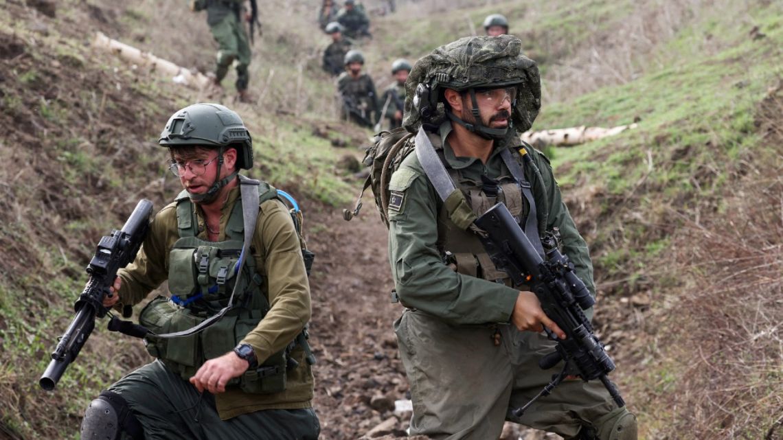 Members of the Israeli Army's infantry 6th brigade take part in an assault coordination exercise near Moshav Kidmat Tsvi in the Israel-annexed Golan Heights on December 7, 2023, amid ongoing cross-border tensions as fighting continues with Hamas militants in the southern Gaza Strip. 