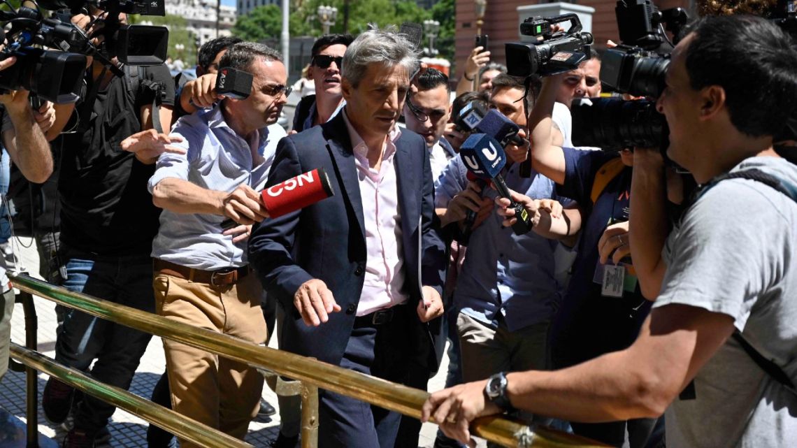 Economy Minister Luis Caputo leaves the Casa Rosada presidential palace in Buenos Aires.
